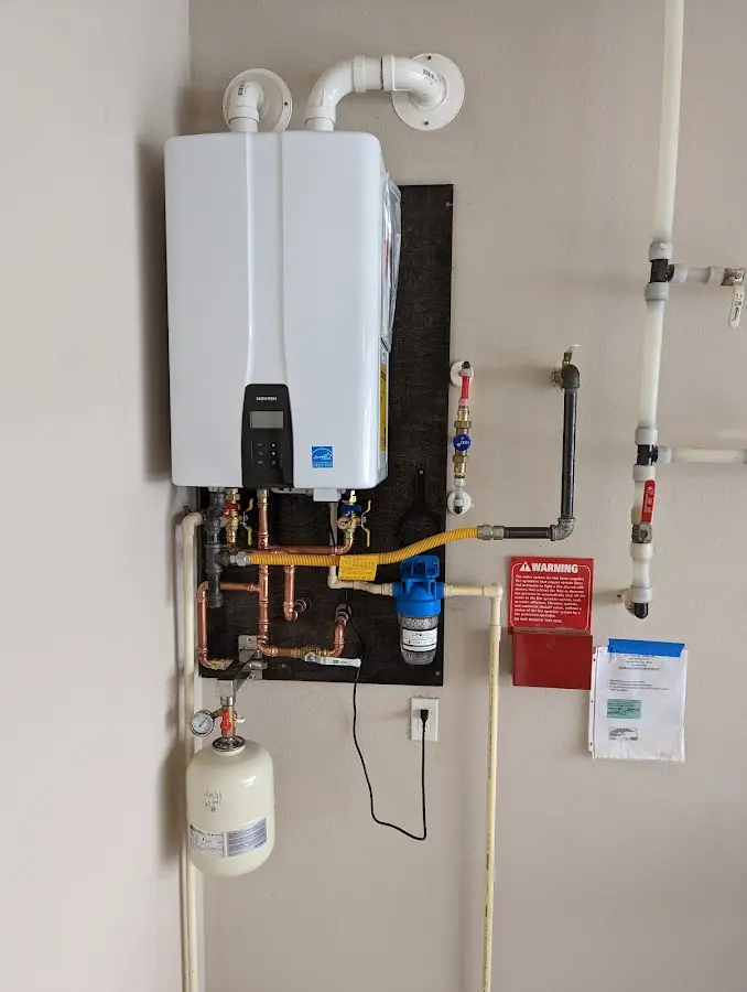 Professional plumber installing copper piping in a Upper Saucon home